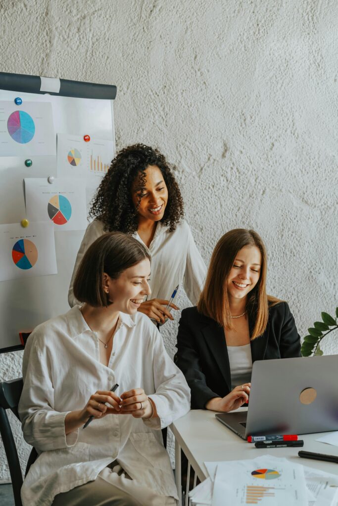 pexels-photo-8145247-8145247 Women in the Office Looking at Laptop Screen Smiling